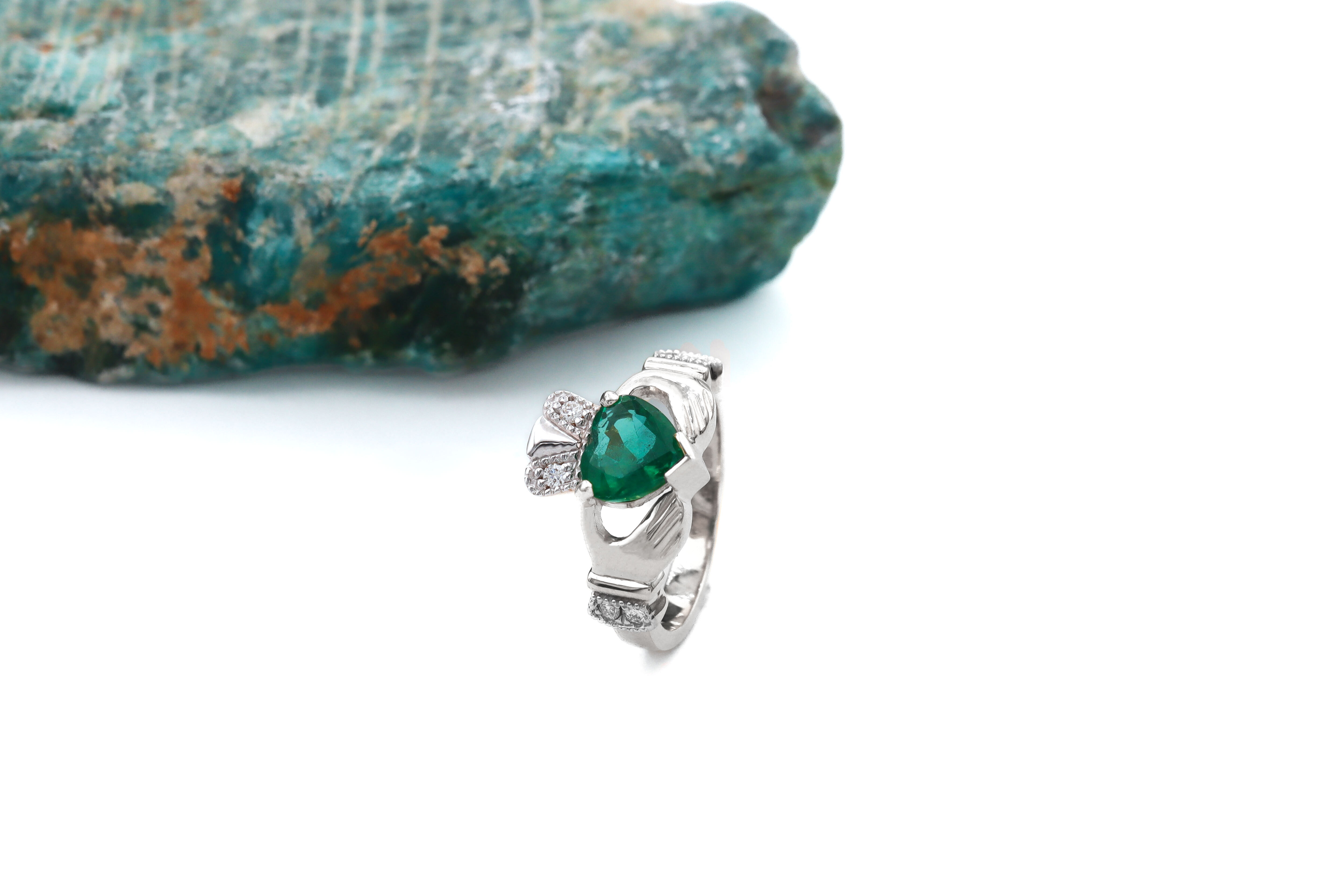Womens Polished Platinum Claddagh 1.00ct Natural Emerald Ring. Side View.
