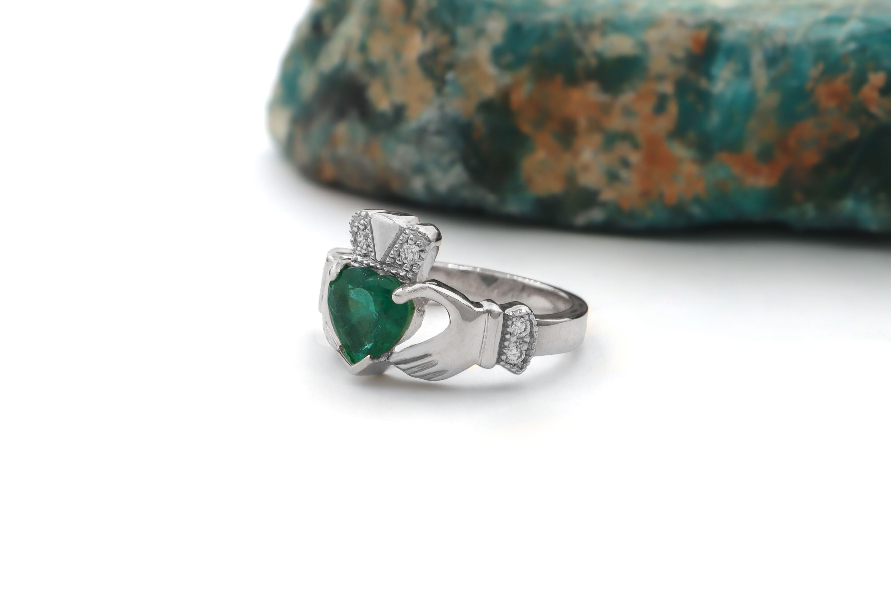 Striking Platinum Claddagh 1.00ct Natural Emerald Engagement Ring For Women With a Polished Finish. Side View.