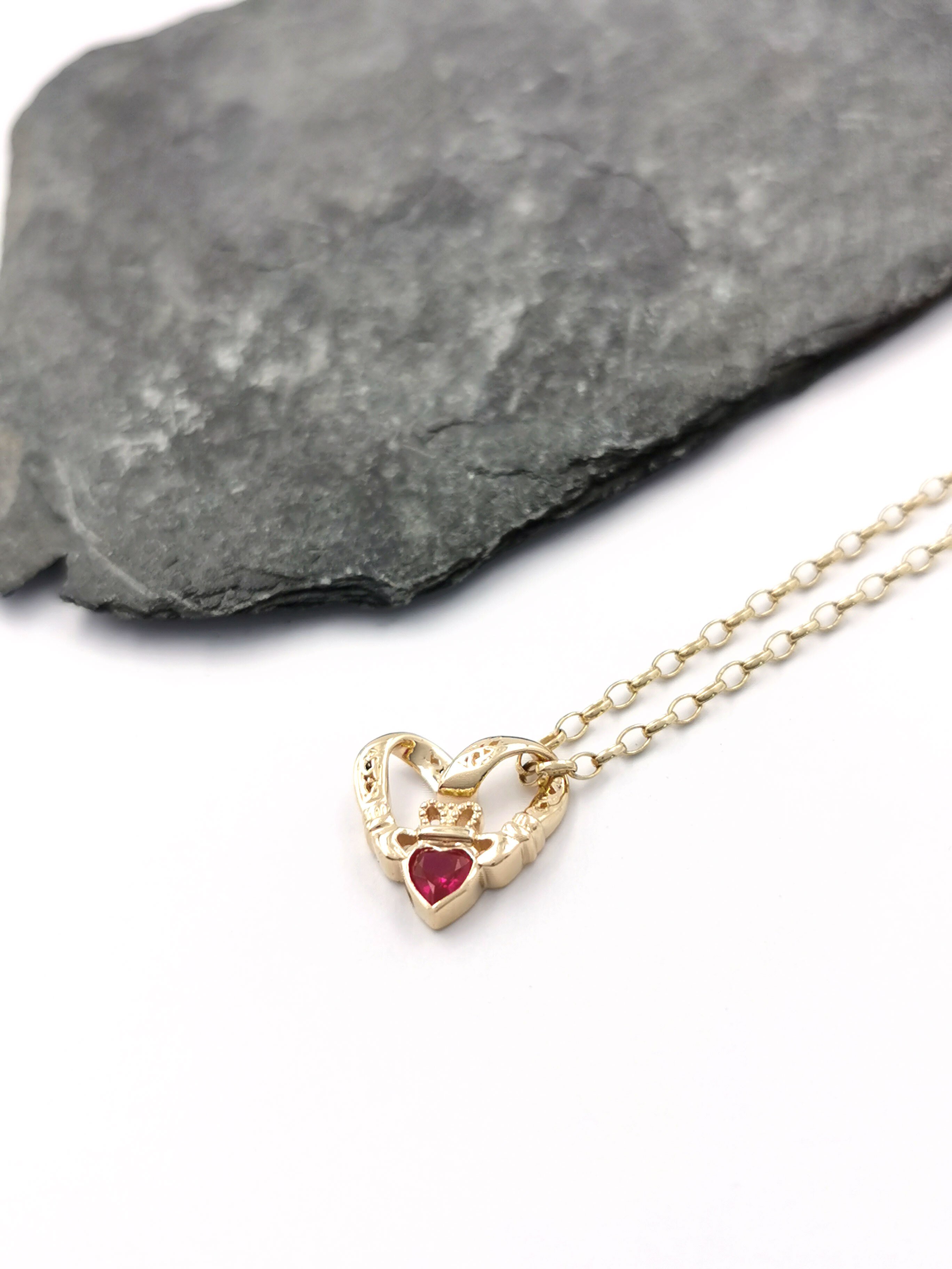 Womens Claddagh Necklace in 9K Yellow Gold. Pictured Flat.