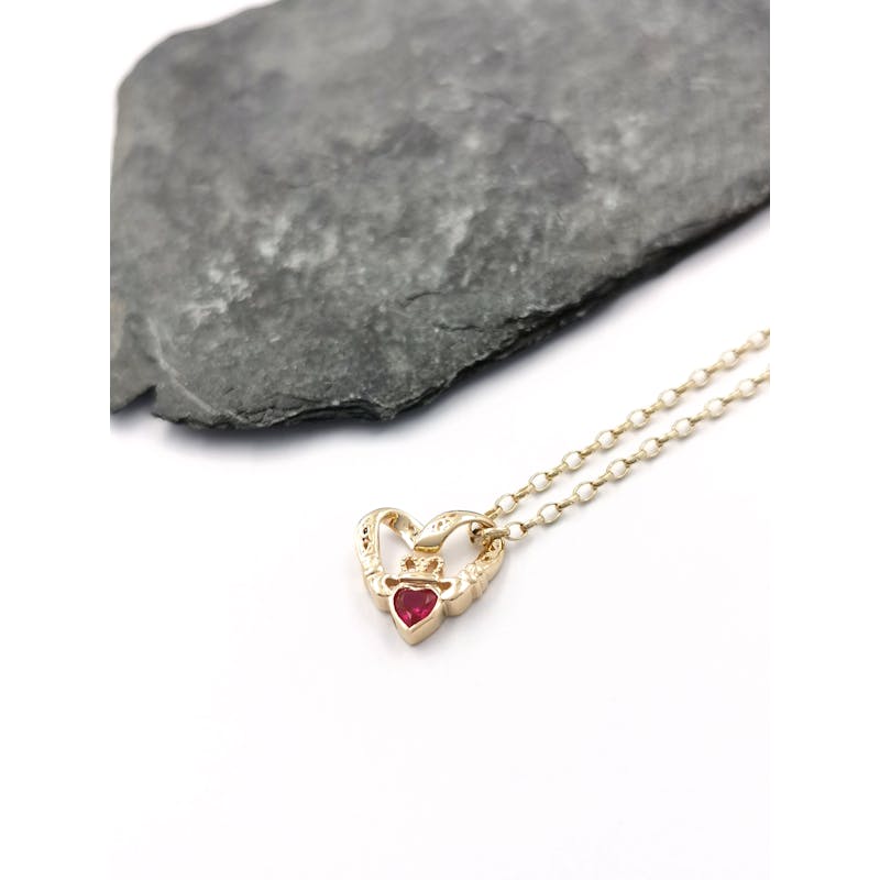 Womens Claddagh Necklace in 9K Yellow Gold. Pictured Flat.