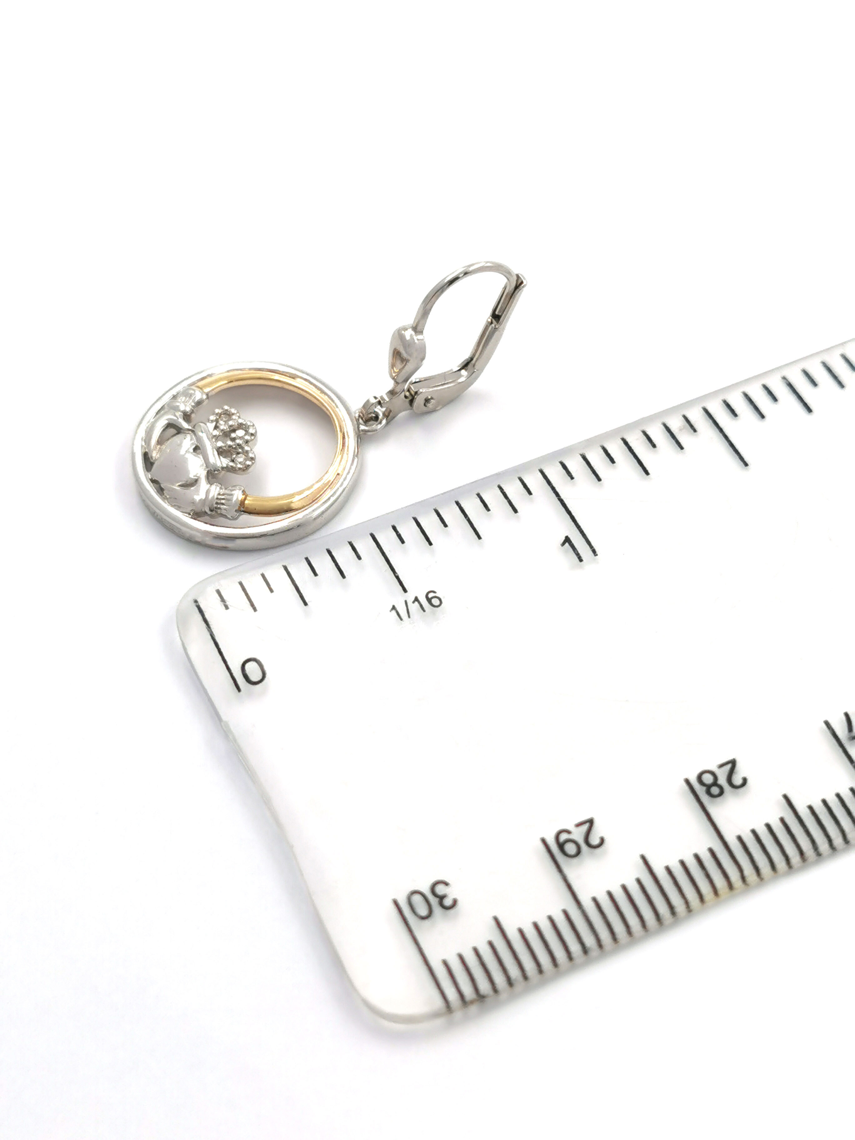 Authentic Sterling Silver & 10K Yellow Gold Claddagh Earrings With a Polished Finish For Women. Picture For Scale.