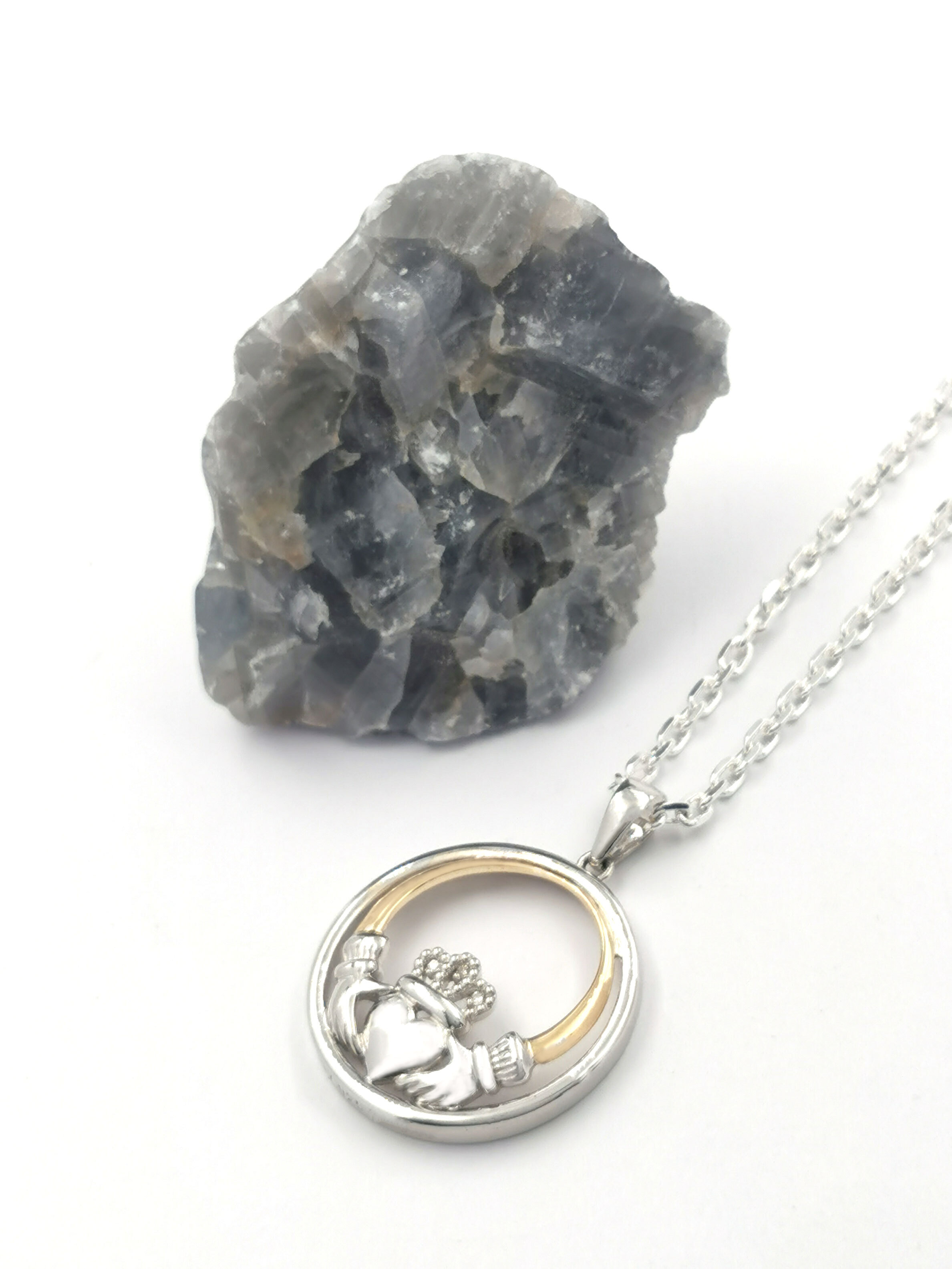 Womens Real Polished Sterling Silver & 10K Yellow Gold Claddagh Necklace. Pictured Flat.