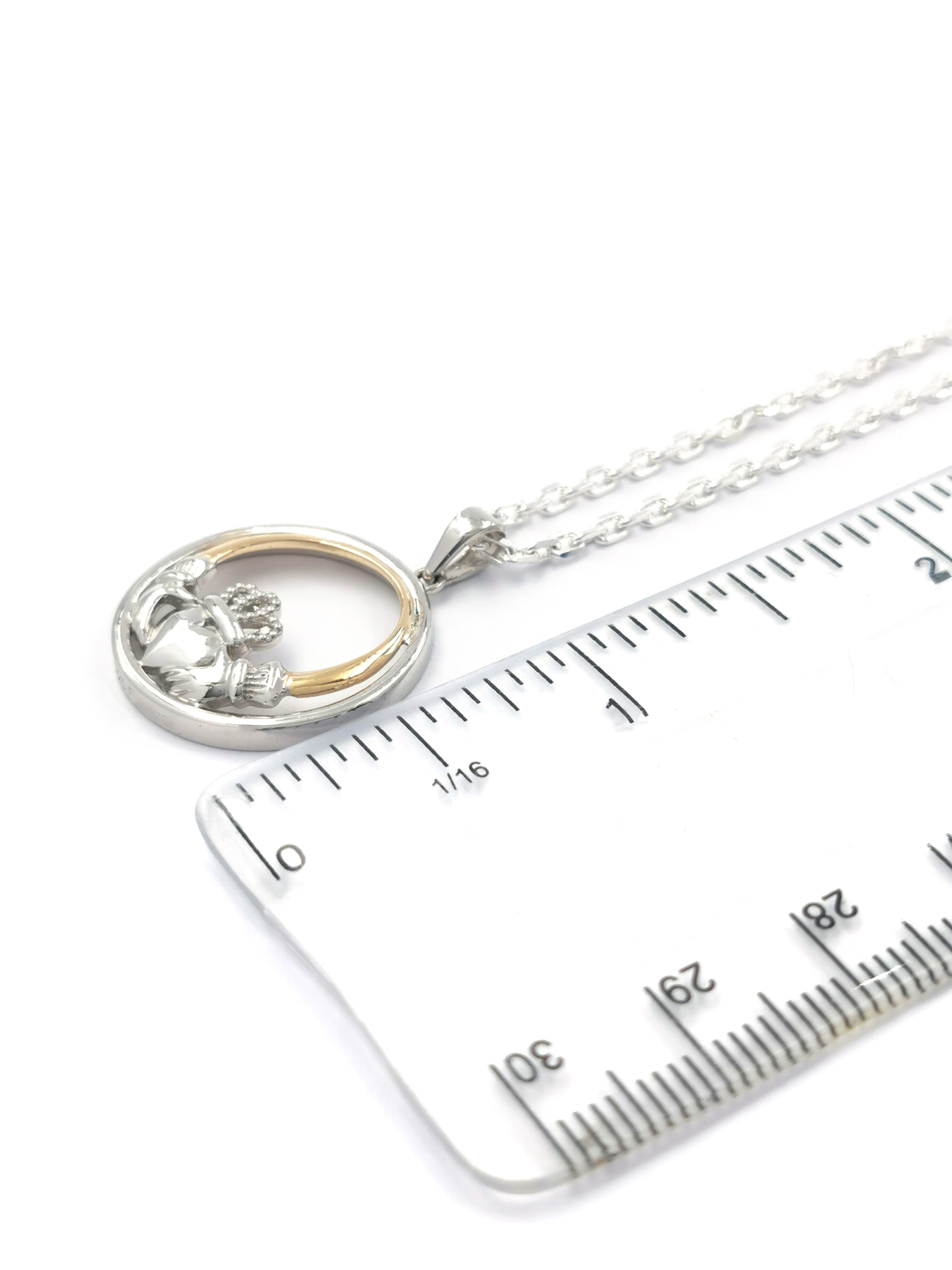 Gorgeous Sterling Silver & 10K Yellow Gold Claddagh Necklace With a Polished Finish For Women. Picture For Scale.