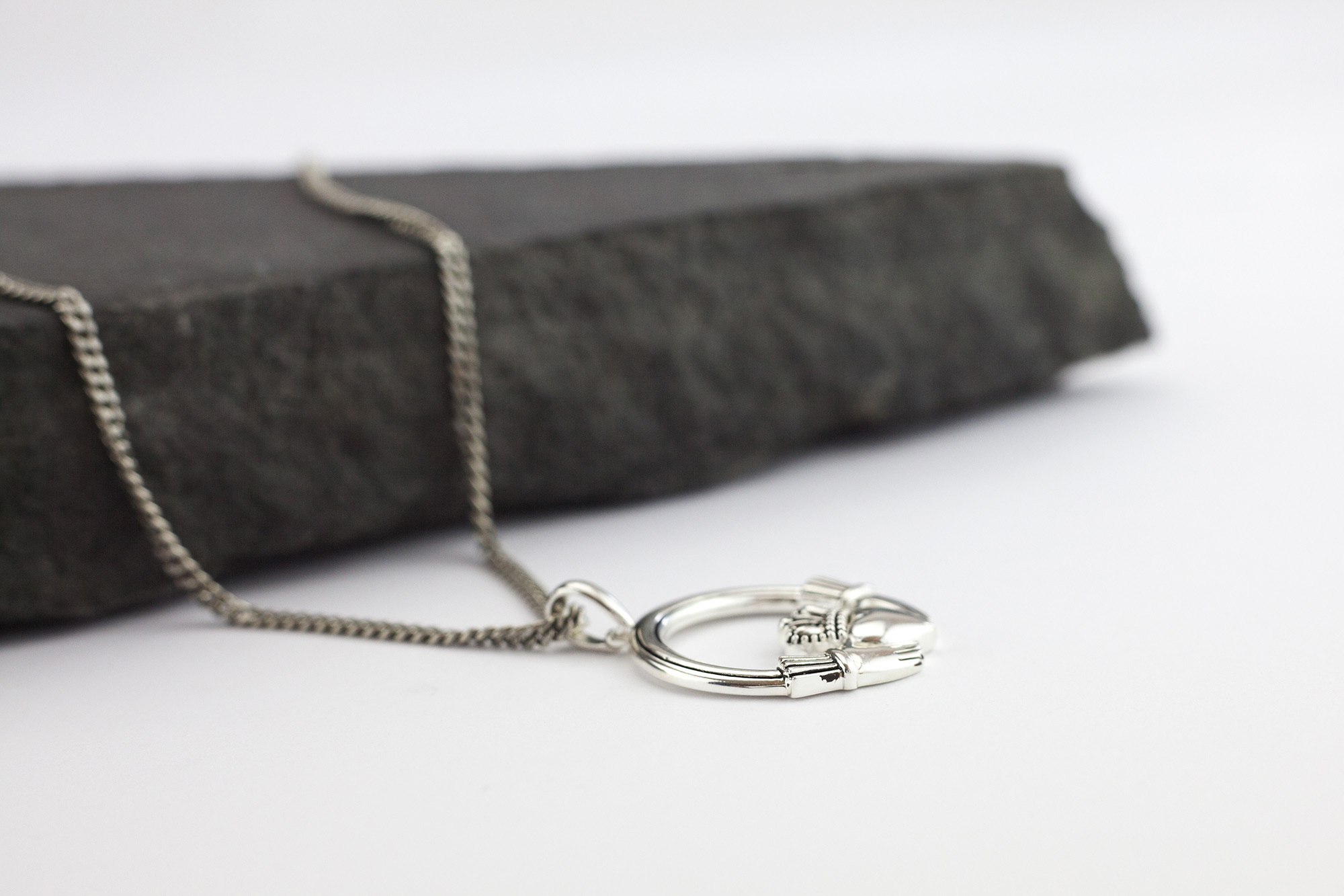 Claddagh Necklace in Sterling Silver. Pictured Flat.