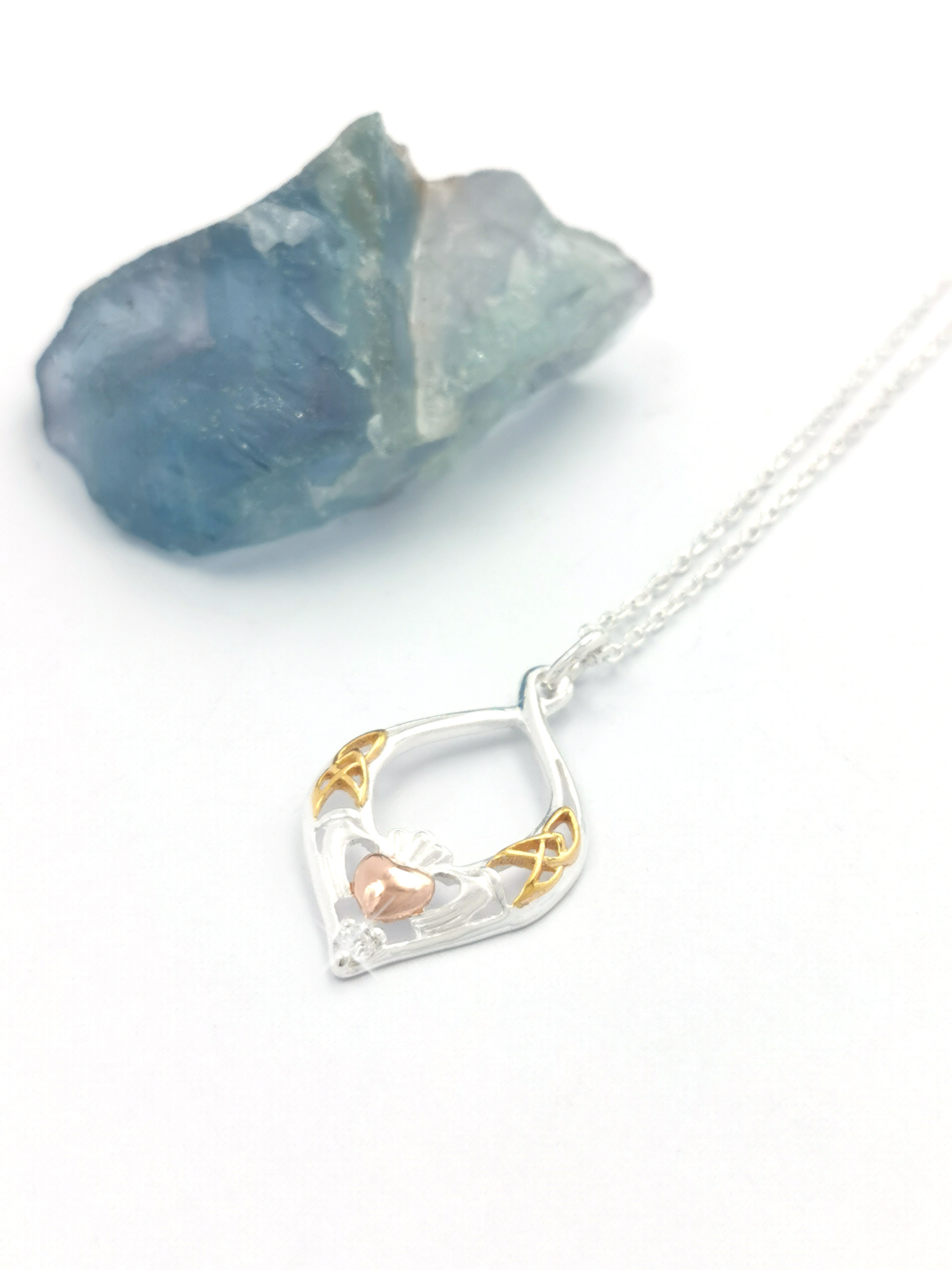 Attractive Sterling Silver Claddagh & Trinity Knot Necklace For Women. Pictured Flat.