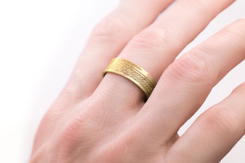 Irish Yellow Gold Ogham & Trinity Knot 7.3mm Ring With a Florentine Finish - Model Photo